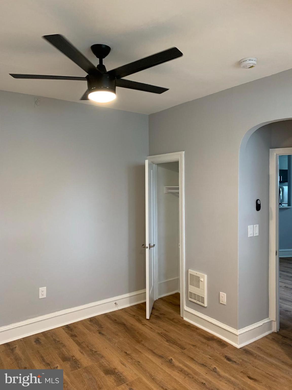 617-625 East Vernon Road, Unit 3A Philadelphia, PA 19119 - Photo 12 of 14 an empty room with wooden floor and a ceiling fan