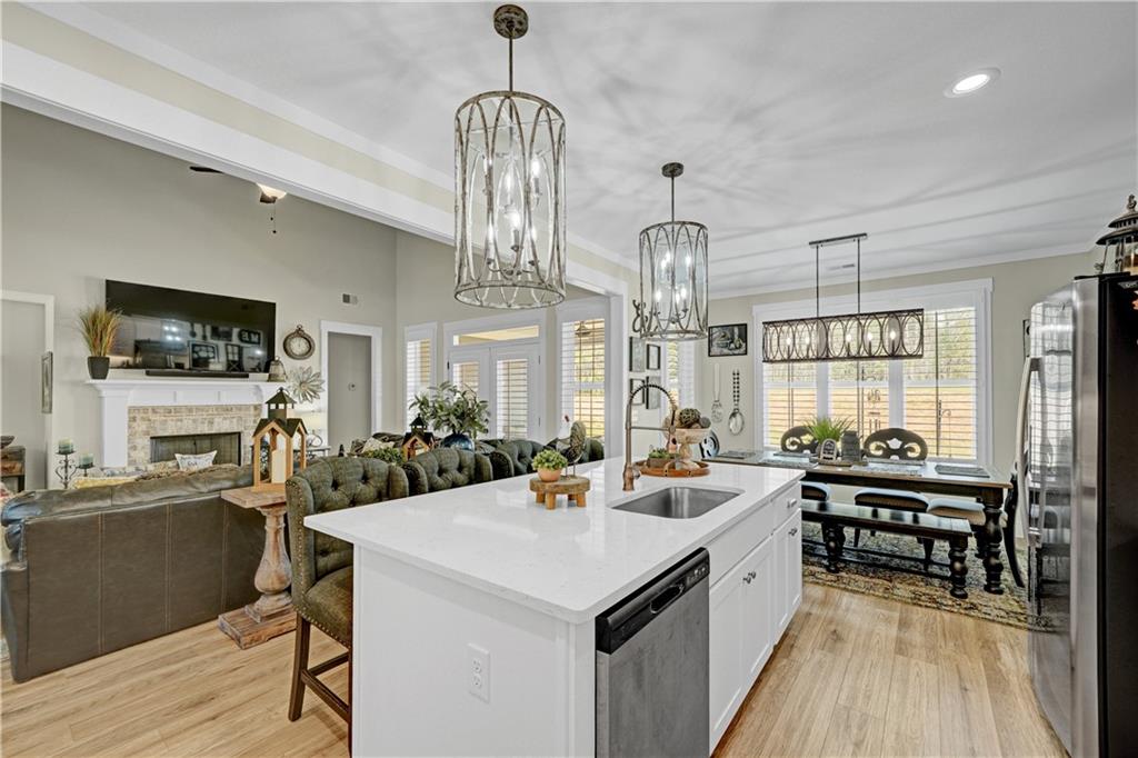 670 Poplar Street Monroe, GA 30655 - Photo 11 of 26 a large kitchen with a counter space a sink stainless steel appliances and cabinets