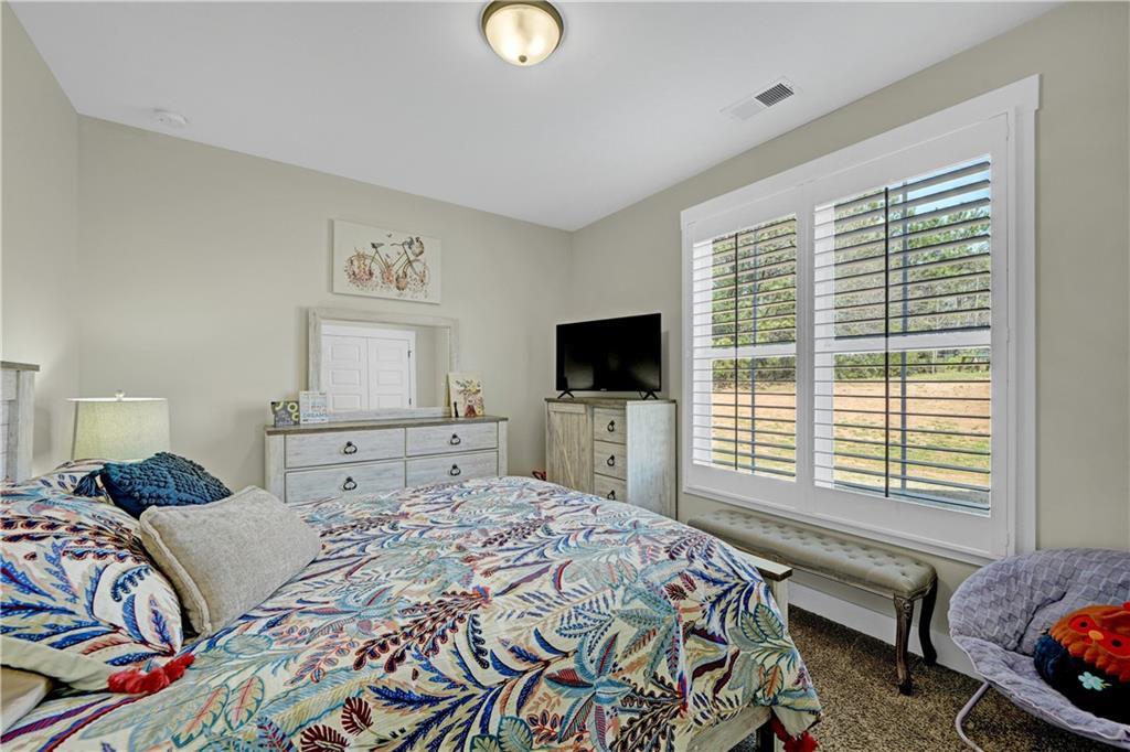 670 Poplar Street Monroe, GA 30655 - Photo 16 of 26 a bedroom with a bed and a television
