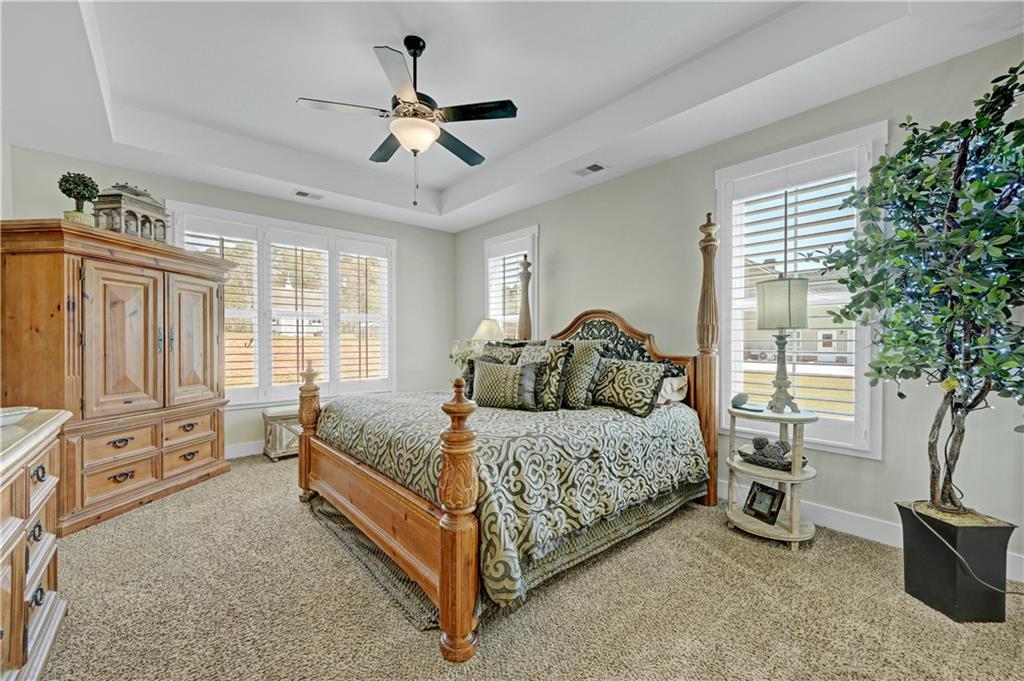 670 Poplar Street Monroe, GA 30655 - Photo 21 of 26 a bedroom with a bed and a chandelier
