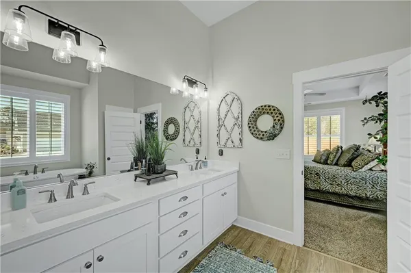 a spacious bathroom with double vanity and a mirror