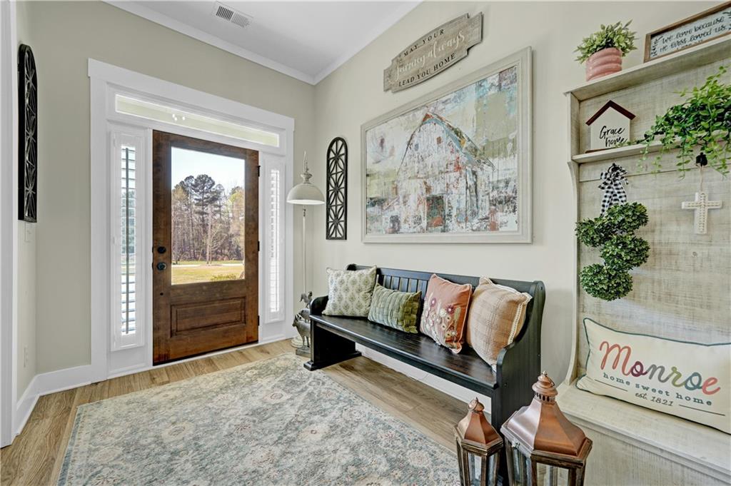 670 Poplar Street Monroe, GA 30655 - Photo 3 of 26 a bedroom with furniture and a window