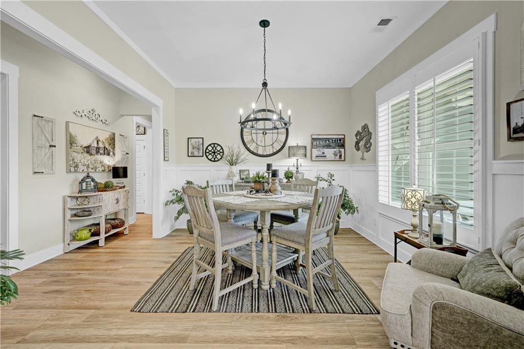 670 Poplar Street Monroe, GA 30655 - Photo 4 of 26 a dining room with furniture window wooden floor