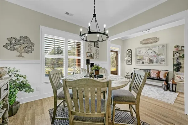 a view of a dining room with furniture window and wooden floor