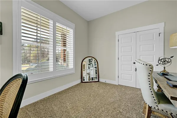 a view of a bedroom with furniture and window