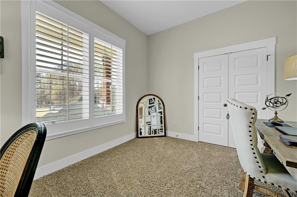 670 Poplar Street Monroe, GA 30655 - Photo 6 of 26 a view of a bedroom with furniture and window