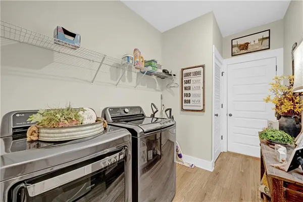 a kitchen with stainless steel appliances a white stove top oven and a dining table