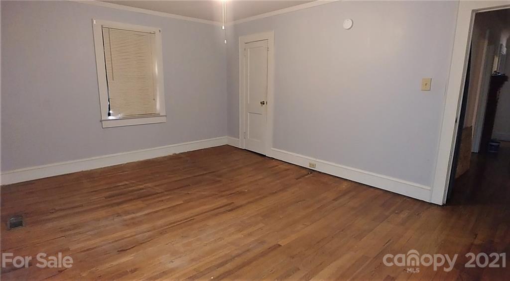 1138 Old York Road Chester, SC 29706 - Photo 14 of 28 a view of an empty room with wooden floor and a window