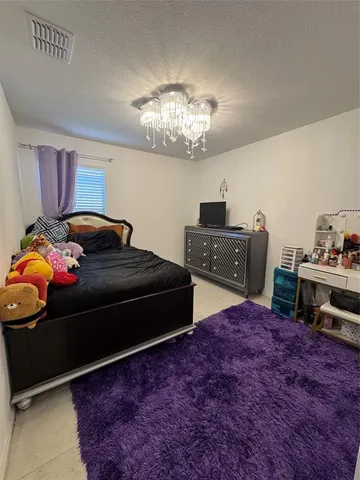 a bedroom with a bed and a dresser in it