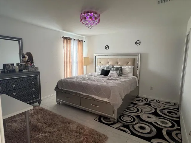 a bedroom with a bed and a dresser in it