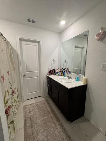 a bathroom with a sink vanity and mirror