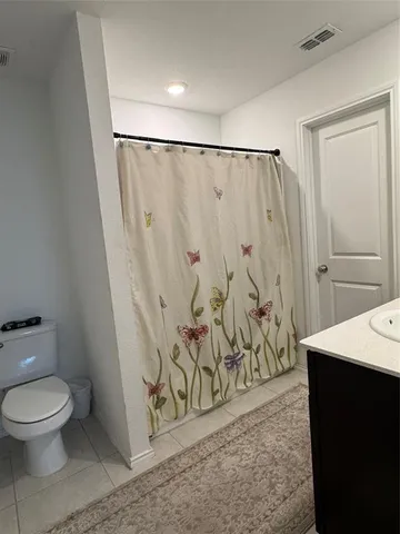 a bathroom with a shower toilet and sink