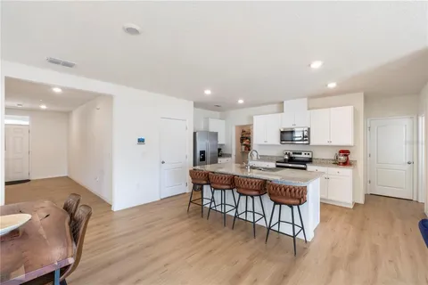 a kitchen with sink cabinets and dining table