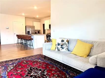 a living room with furniture and wooden floor