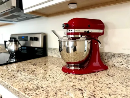 a kitchen with granite countertop a stove a sink and a granite counter tops