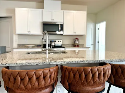 a kitchen with a sink cabinets and wooden floor