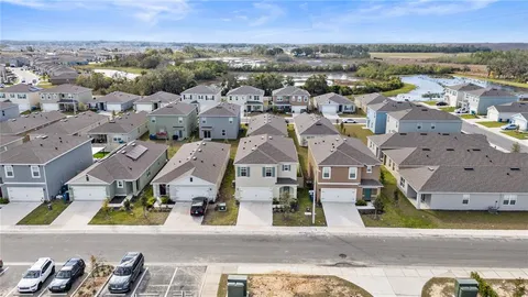an aerial view of residential houses with outdoor space