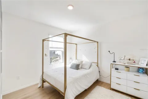 a bedroom with a bed a desk and chair