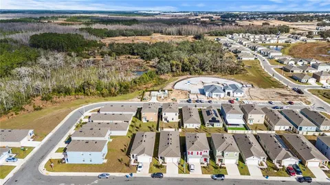 an aerial view of a residential houses with outdoor space