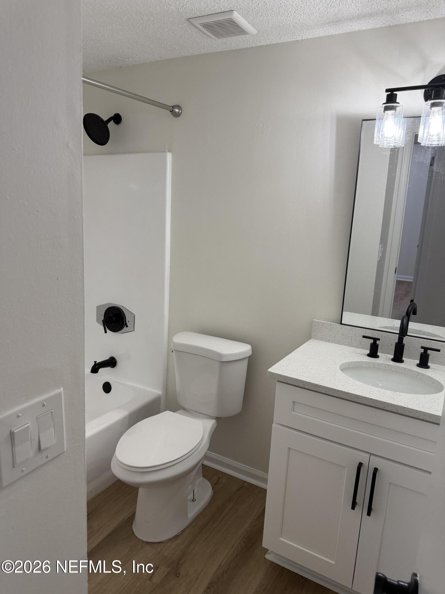 7539 Walden Road Jacksonville, FL 32244 - Photo 14 of 18 a white toilet sitting next to a bathroom sink