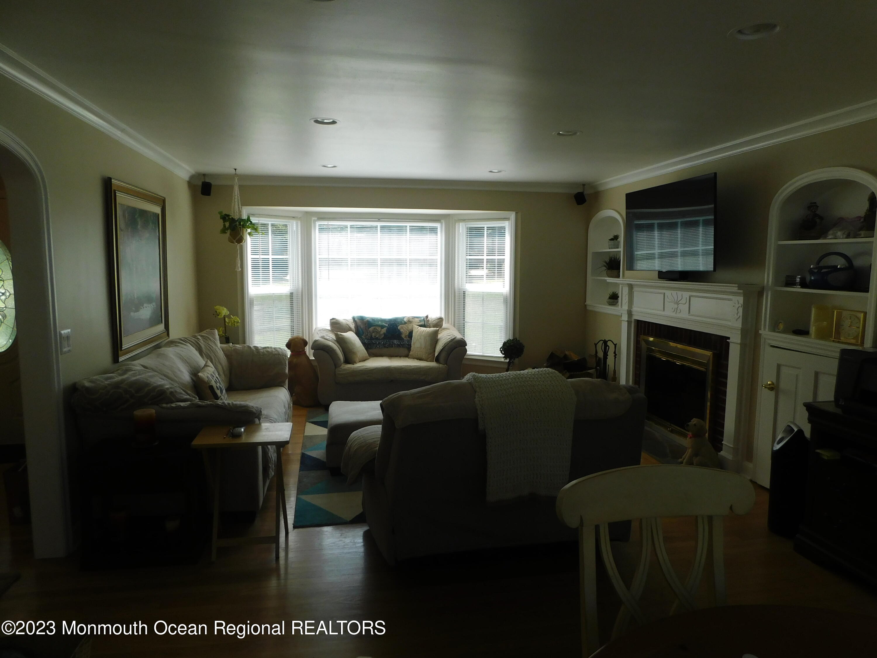 295 Broadway Freehold, NJ 07728 - Photo 15 of 39 a living room with furniture a flat screen tv and a fireplace