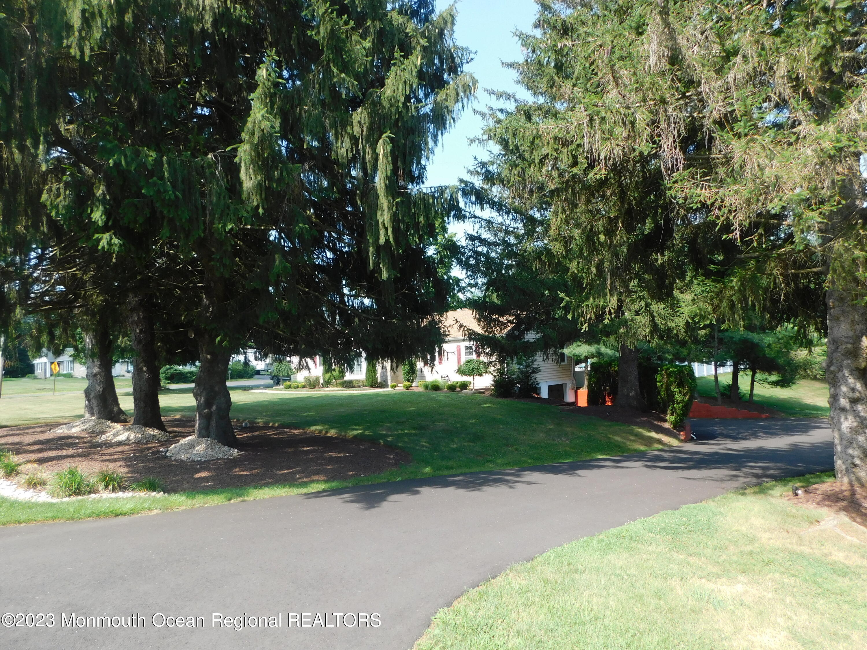 295 Broadway Freehold, NJ 07728 - Photo 18 of 39 a view of a street with a building and trees in the background