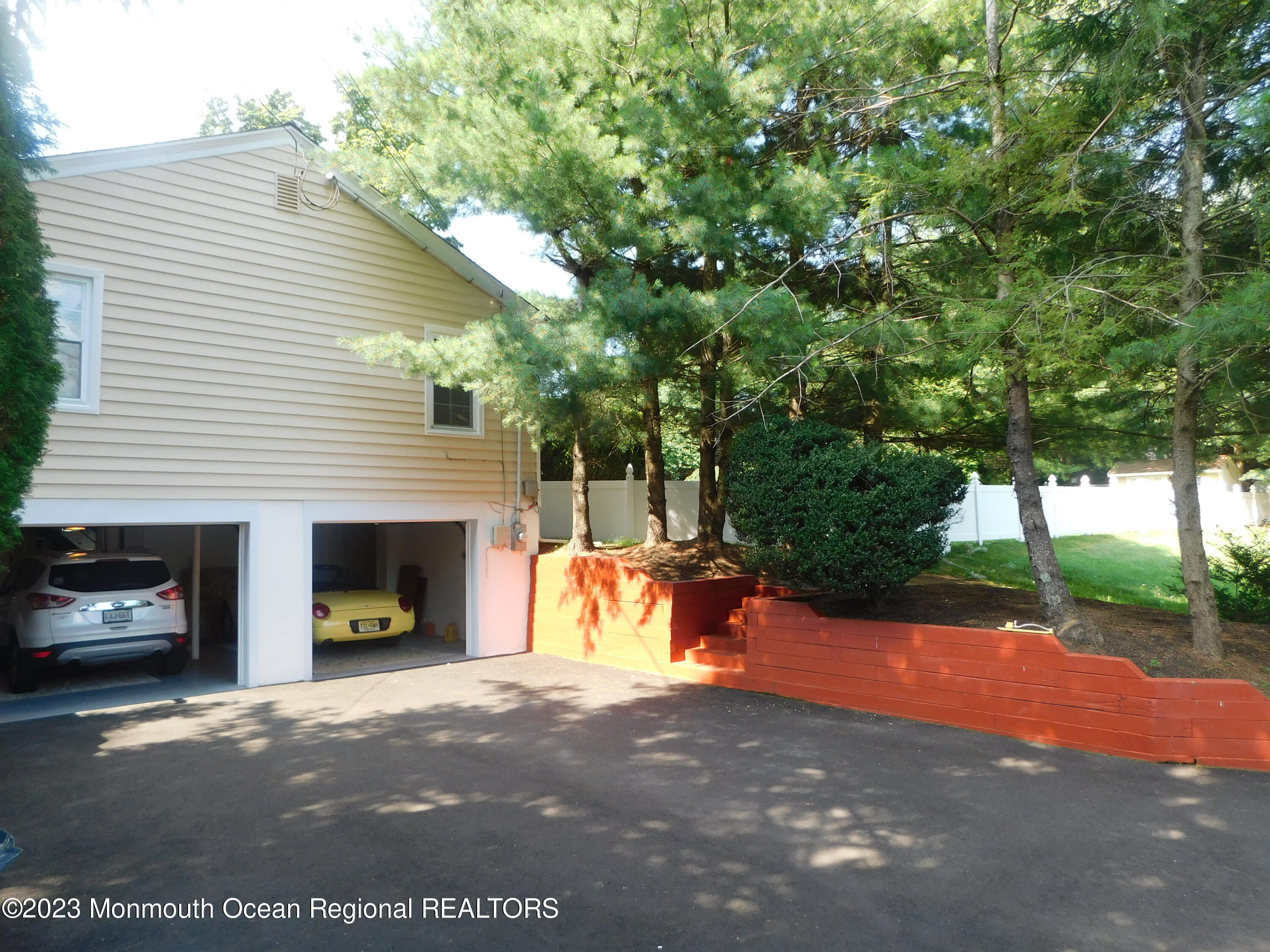 295 Broadway Freehold, NJ 07728 - Photo 20 of 39 a view of a house with a yard and a garage
