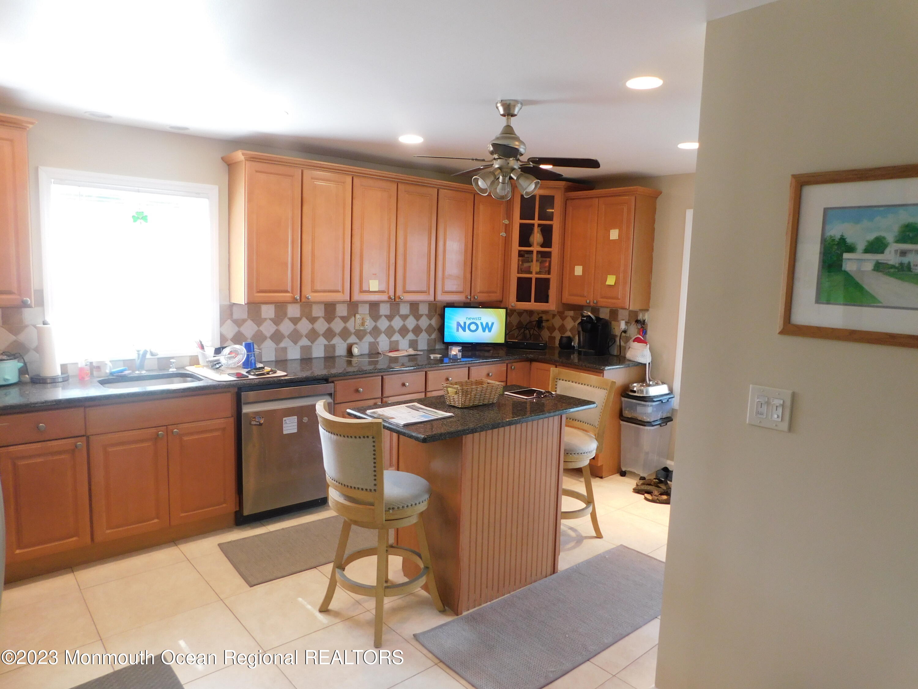 295 Broadway Freehold, NJ 07728 - Photo 3 of 39 a kitchen with granite countertop a sink stove and cabinets