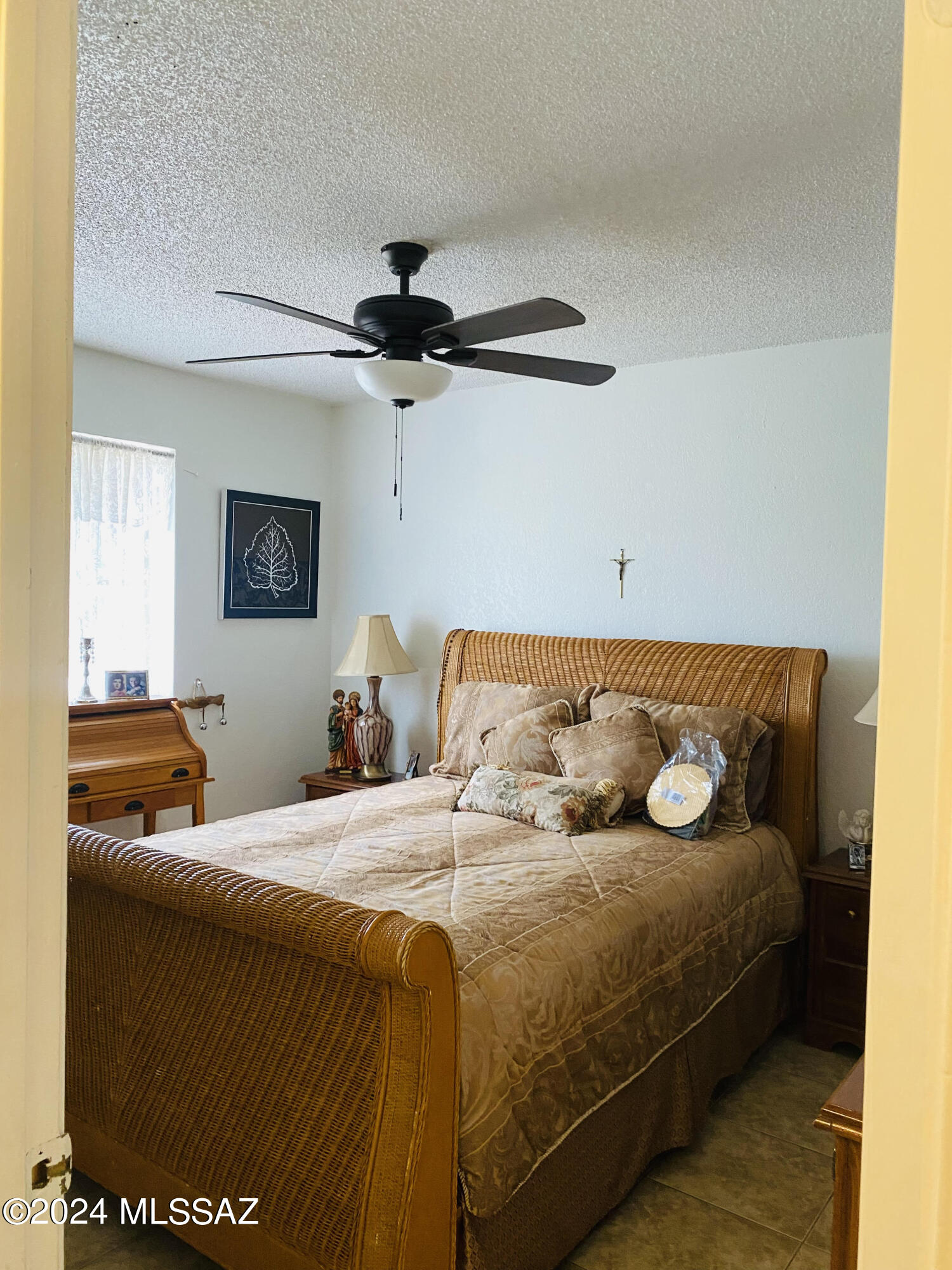 84 Alami Court Rio Rico, AZ 85648 - Photo 17 of 20 a bedroom with a bed and a chandelier