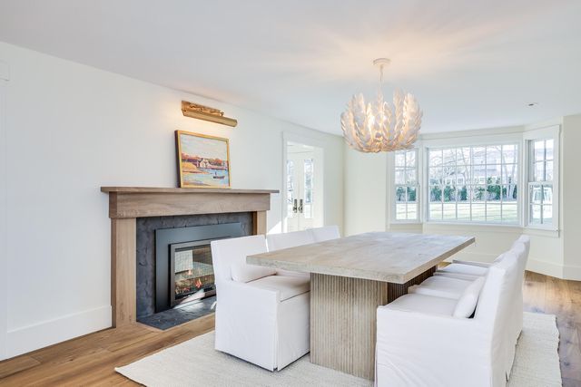 a view of hall way with furniture and chandelier
