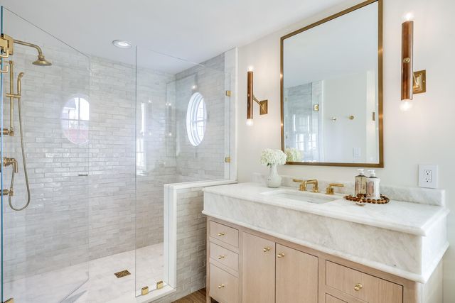 a bathroom with a shower sink and mirror