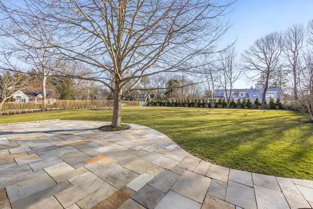a view of yard with swimming pool and green space