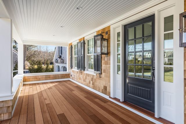 a view of a room with wooden floor and windows