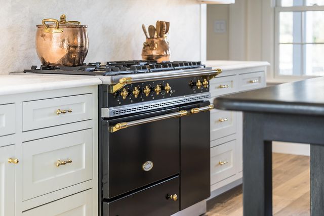 a stove top oven sitting inside of a kitchen