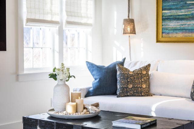 a living room with furniture flowerpot and window