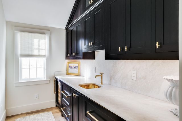 a kitchen with stainless steel appliances a sink a stove a microwave a sink and cabinets