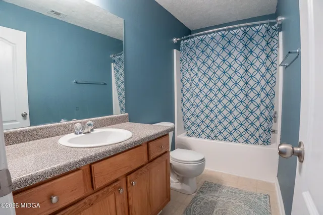 a bed sitting in a bedroom next to a window