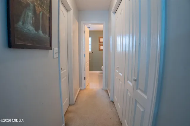 a bathroom with a granite countertop sink a toilet and a mirror