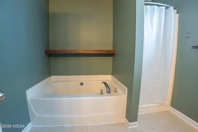 a backyard of a house with large trees and plants