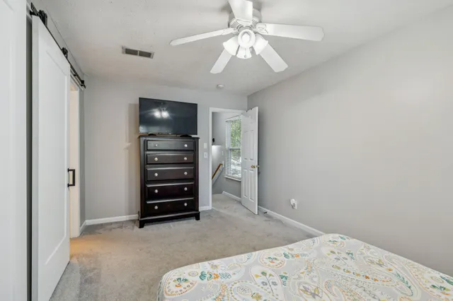 a view of a bedroom with closet and cabinet