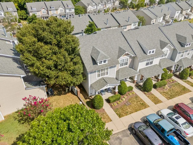 an aerial view of a house with a yard