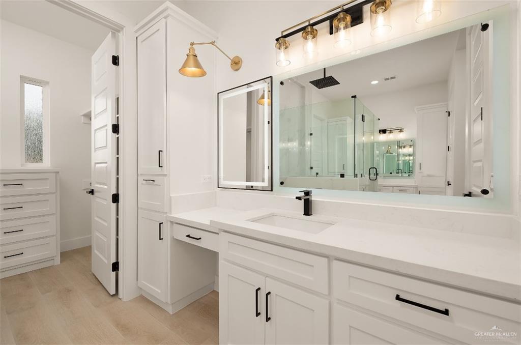 8003 North 55th Lane McAllen, TX 78573 - Photo 13 of 20 a bathroom with a sink and a mirror
