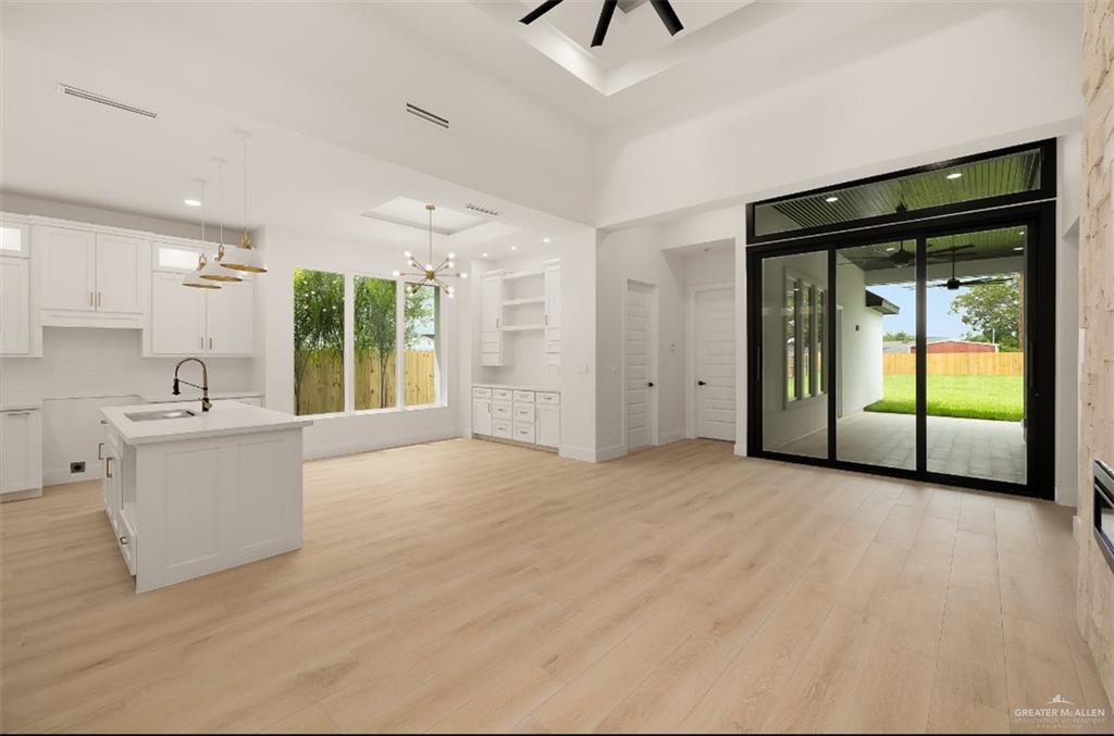 8003 North 55th Lane McAllen, TX 78573 - Photo 6 of 20 a view of an empty room with a fireplace and a window