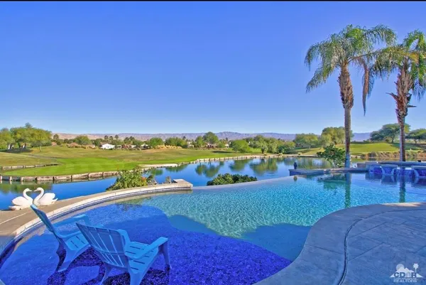 a view of swimming pool with outdoor seating space