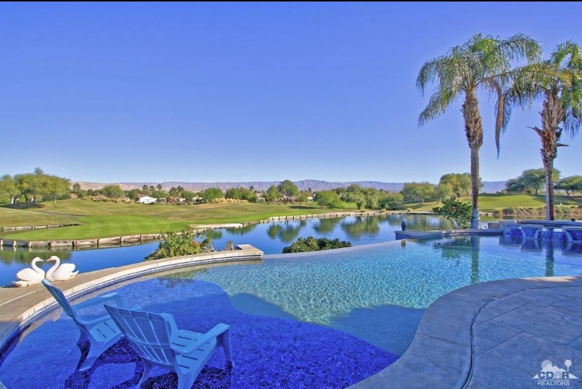 a view of swimming pool with outdoor seating space