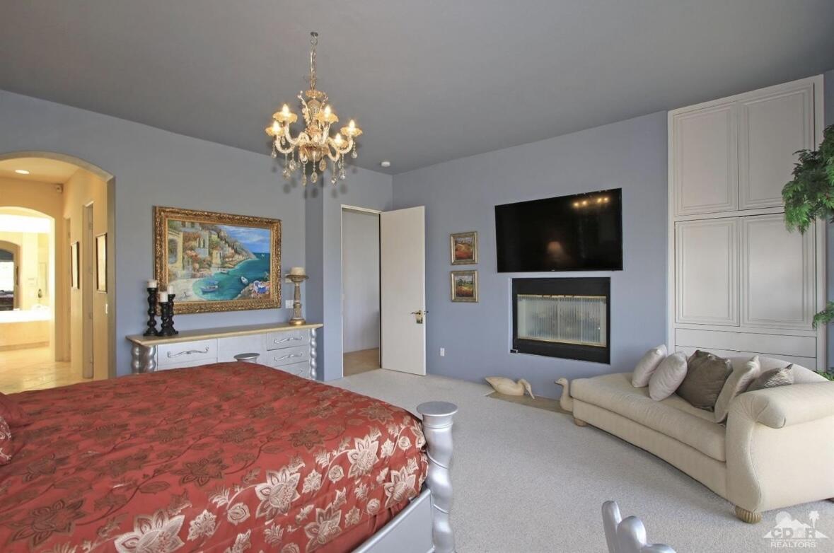 104 Loch Lomond Road Rancho Mirage, CA 92270 - Photo 13 of 27 a bedroom with a bed and a flat screen tv