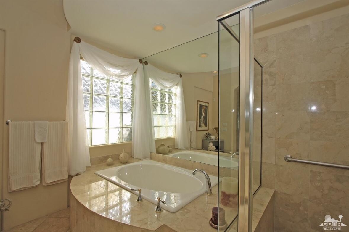 104 Loch Lomond Road Rancho Mirage, CA 92270 - Photo 14 of 27 a bathroom with a tub and shower