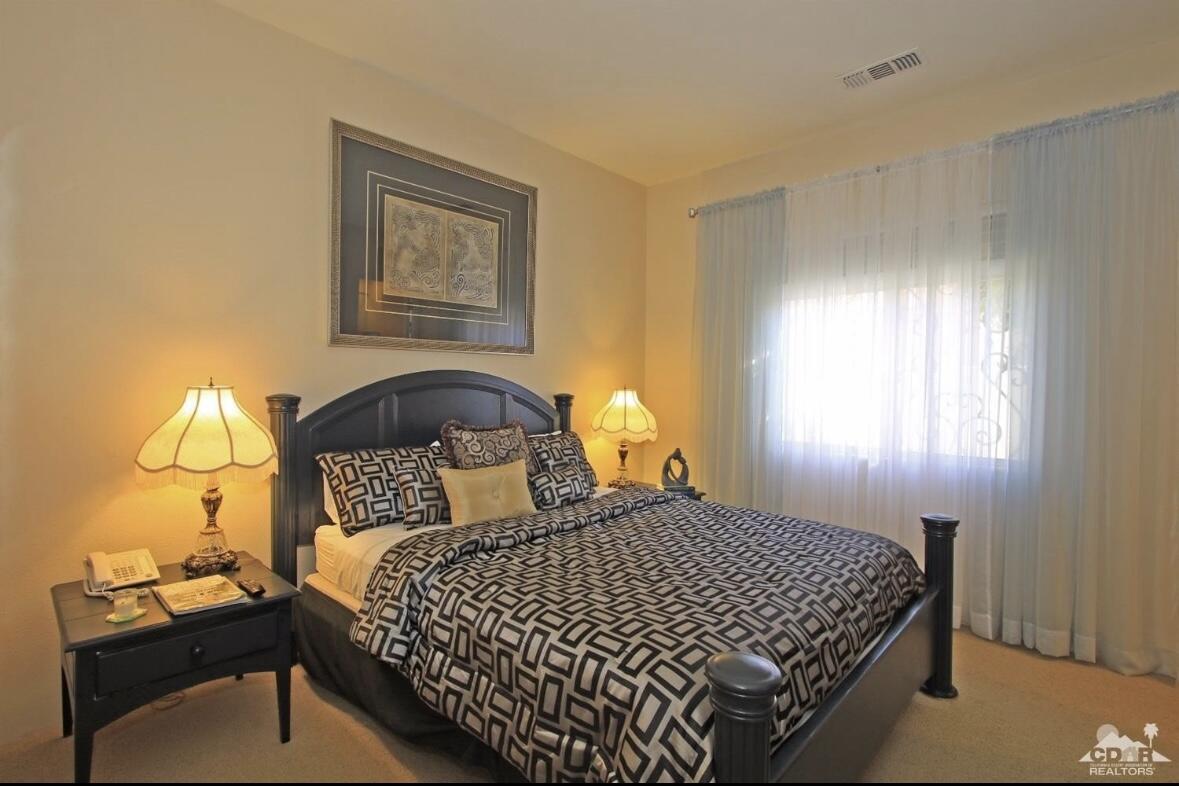 104 Loch Lomond Road Rancho Mirage, CA 92270 - Photo 16 of 27 a bedroom with a bed and window