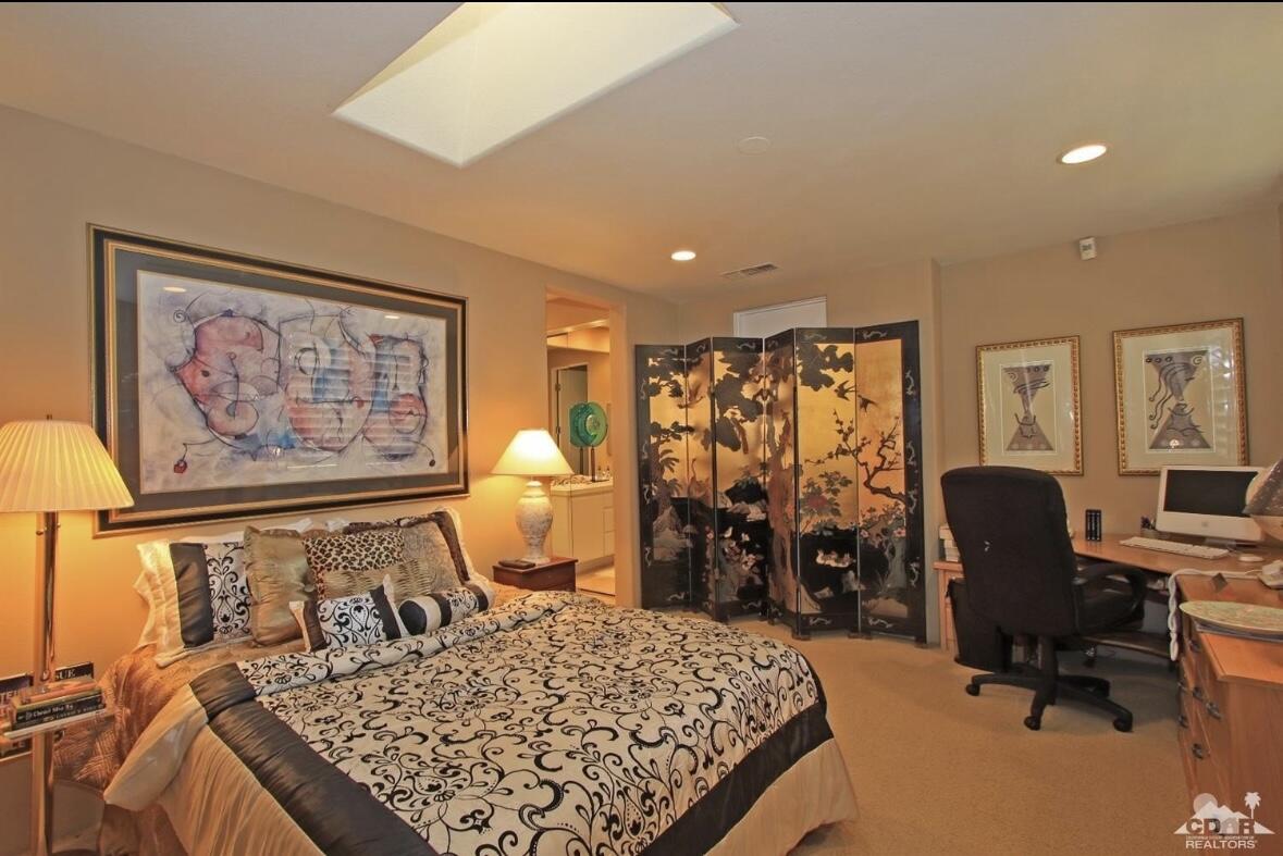 104 Loch Lomond Road Rancho Mirage, CA 92270 - Photo 17 of 27 a bedroom with a bed a computer on desk and a dresser next to a window