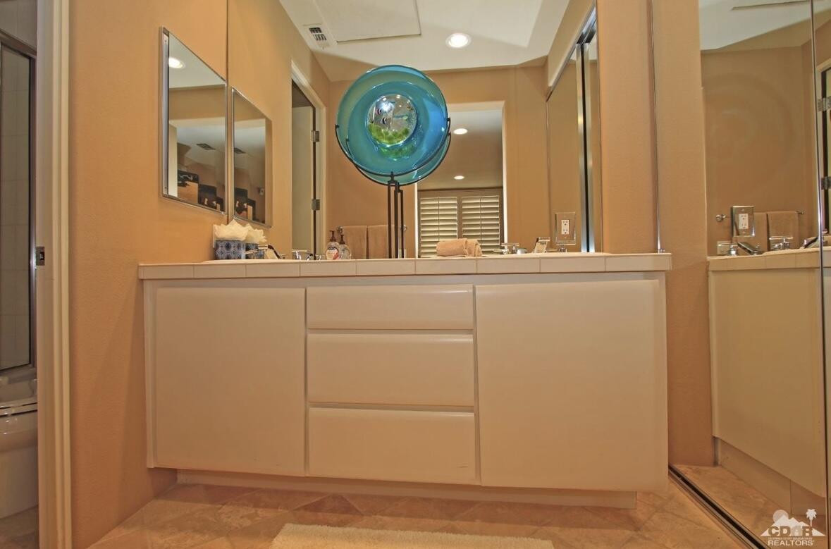 104 Loch Lomond Road Rancho Mirage, CA 92270 - Photo 18 of 27 a bathroom with a sink and a mirror